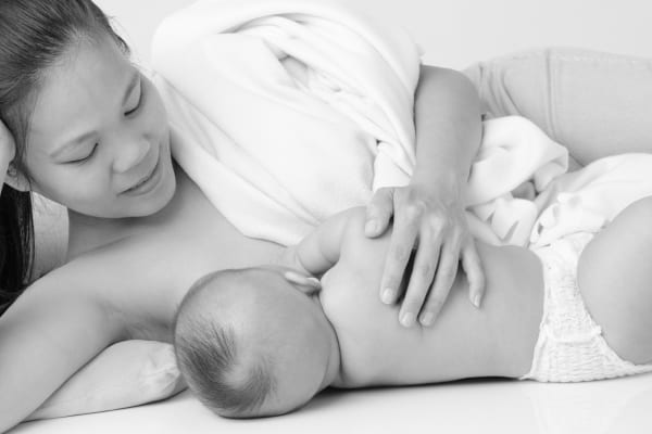 Black and white picture of mother breastfeeding baby